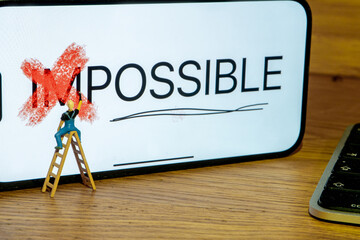 Painter on stepladder redrawing on white board letter I and m of word impossible creating new word...