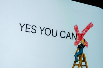 Painter on stepladder redrawing on white board letter t word can't creating new sentence yes you...