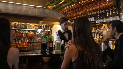 Feeling good smell tasty serving special drink to VIP customer with couple in mist smoky classical mixing whiskey liquor cocktail by smart bartender opening at beverage counter bar luxury. Vinosity.