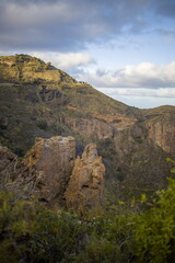 Rugged mountain landscape Bandama Caldera, Gran Canaria, with a prominent rock cliff or outcrop.