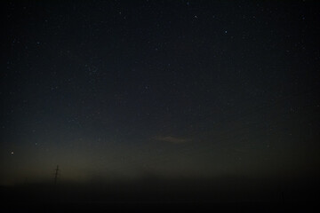 Electricity tower at night with sky full of the stars near village Vendoli, Czech republic