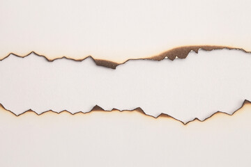 Burned Torn, ripped paper pieces wave lines hole gap frame. Beige, brown copy space texture...