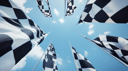 Black and white checkered motor sports flags curling in the breeze with crossed flagpoles