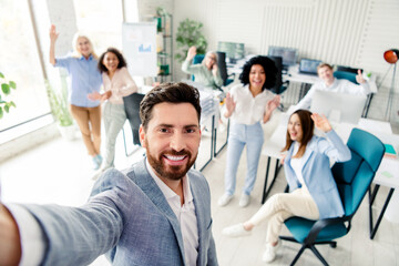 Obraz premium Professional team celebrating success together in a bright modern office environment