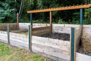 Port Townsend, Washington State, USA. Wooden compost bins for various stages of decomposition, in a...