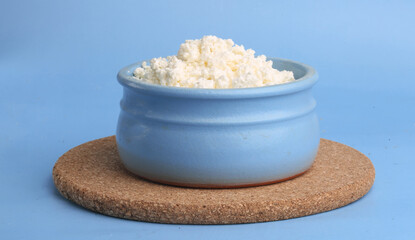 bowl of cottage cheese on a blue background