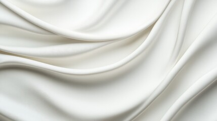 Fototapeta premium A smooth, flowing surface of white fabric, showcasing elegant folds and a soft texture, ideal for fashion and home decor.