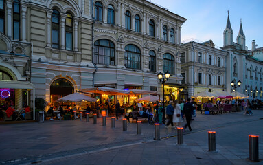 Nikolskaya street with tables of restaurant in Moscow, Russia. Architecture and landmarks of Moscow. Night cityscape of Moscow