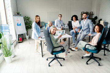 Diverse group of colleagues working together in a modern, well-lit office setting