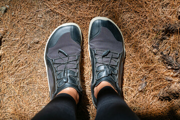 Woman legs with barefoot hiking shoes in the summer mountain 