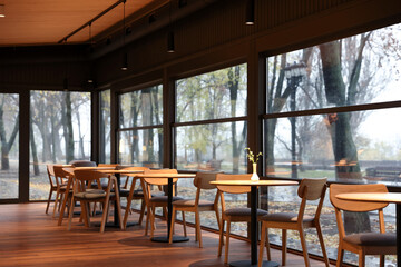 Stylish cafe with large windows and comfortable furniture. Interior design