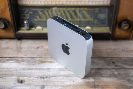 Mac Mini M1 Apple computer held, retro radio, old and new technology portability, vintage aesthetic, working remotely in cozy home environment, Frankfurt - February 4, 2025