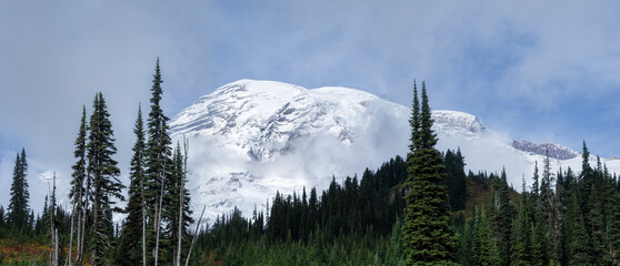 Washington State, Mount Rainier National Park. Mount Rainier panorama, clouds shrouding snow covered mountain, view from the Paradise Valley
