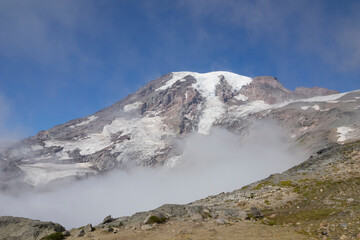 Fototapeta premium Washington State, Mount Rainier National Park. Mount Rainier, snowcapped Mount Rainer with low level clouds, view from 7000 foot level