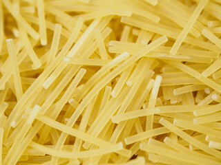 Close-up of small, thin vermicelli filini pasta. Delicate strands create a fine, textured food...