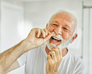 man tooth bathroom hygiene senior morning routine floss dental care oral mouth product white thread brushing elderly home retirement mirror health cleaning