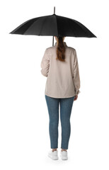 Young woman with black umbrella on white background, back view