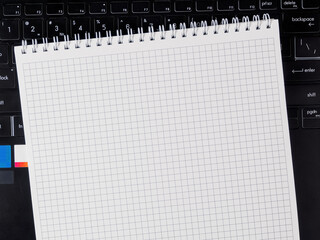 Open blank notebook on laptop. Workspace, free space for notes/ideas. Technology analog tools...