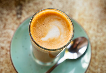 Image of cup of fresh coffee cortado on table, no people