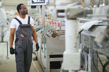 Portrait of industrial engineer. factory worker standing in factory production line