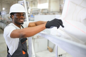 Obraz premium Portrait of African American male engineer in uniform and standing in industrial factory