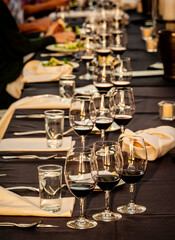 USA, Washington State, Yakima Valley. Glasses of red wine arranged for a tasting at a Red Mountain wine event.