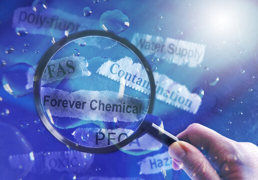 PFAS Forever Chemicals water and newspaper headlines with magnifying glass