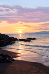Obraz premium Beautiful Ocean Sunset over Rocky Beach with Golden Light Reflecting on Waves and Purple Sky, Seascape Nature Photography