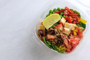 Tasty poke food with seafood and vegetables
