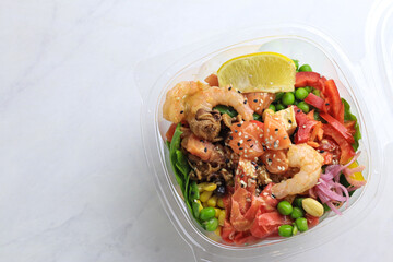 Tasty poke food with seafood and vegetables
