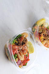 Tasty poke food with seafood and vegetables