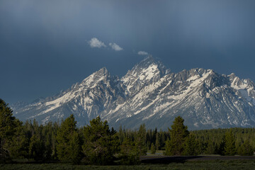 Fototapeta premium USA, Wyoming, Grand Teton National Park. Spring rainstorm nears mountains at sunrise.