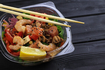 Tasty poke food with seafood and vegetables