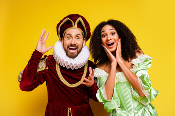Elegant couple in historical costumes portraying aristocratic figures with vibrant yellow...