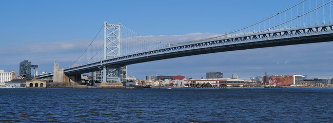 Panoramic image of The architectural beauty that is the Ben Franklin Bridge spanning across the Delaware River between Camden NJ and Philadelphia Pennsylvania