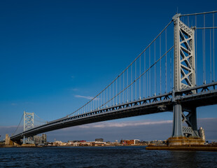 The architectural beauty that is the Ben Franklin Bridge spanning across the Delaware River between Camden NJ and Philadelphia Pennsylvania