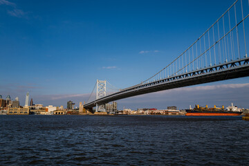 The architectural beauty that is the Ben Franklin Bridge spanning across the Delaware River between Camden NJ and Philadelphia Pennsylvania