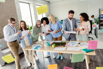 Collaborative meeting in modern office with diverse professionals working together on planning and brainstorming