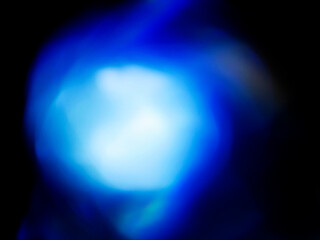 Blue color light leaks on dark background for design and special effects.