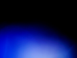 Blue color light leaks on dark background for design and special effects.