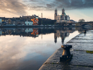 View on Riverside area of Athlone city, Ireland. Old town with long history and educational, shopping and industrial center. Church of Saints Peter and Paul in the background and town bridge
