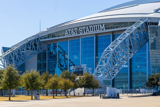 AT and T Stadium surrounded by trees and plants at sunset in Arlington Texas USA