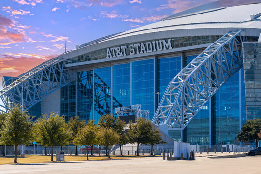 AT and T Stadium surrounded by trees and plants at sunset in Arlington Texas USA