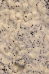 grainy cottage cheese with cream on the table during cooking with spices and chia seeds