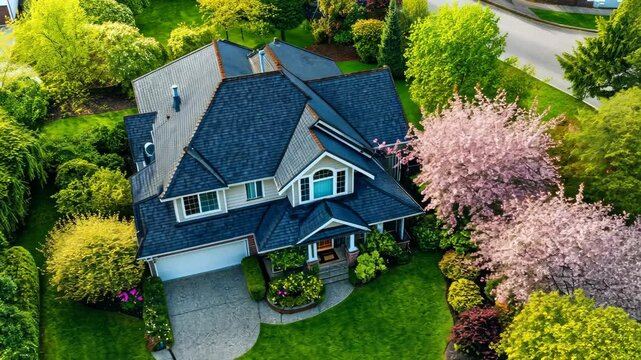 Aerial spring view of suburban house with lush greenery and blossoming trees