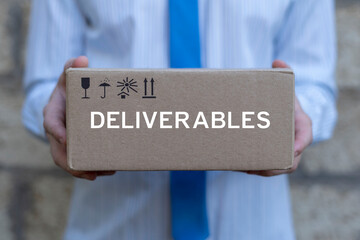 Business person holding cardboard box with word: DELIVERABLES. Postal goods delivery service...