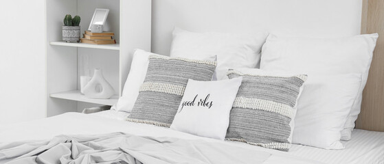 Big comfortable bed in interior of bedroom