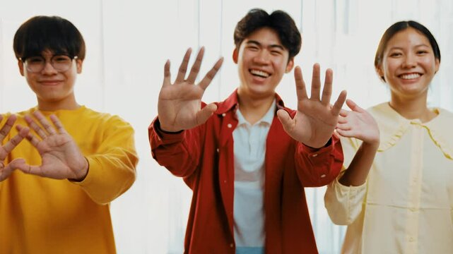 Panoramic video happy asian startup company employee wear colorful casual cloth standing in line together happily wave hand symbolize cheerful teamwork, goodbye coworker, HR agency greeting. Synergic