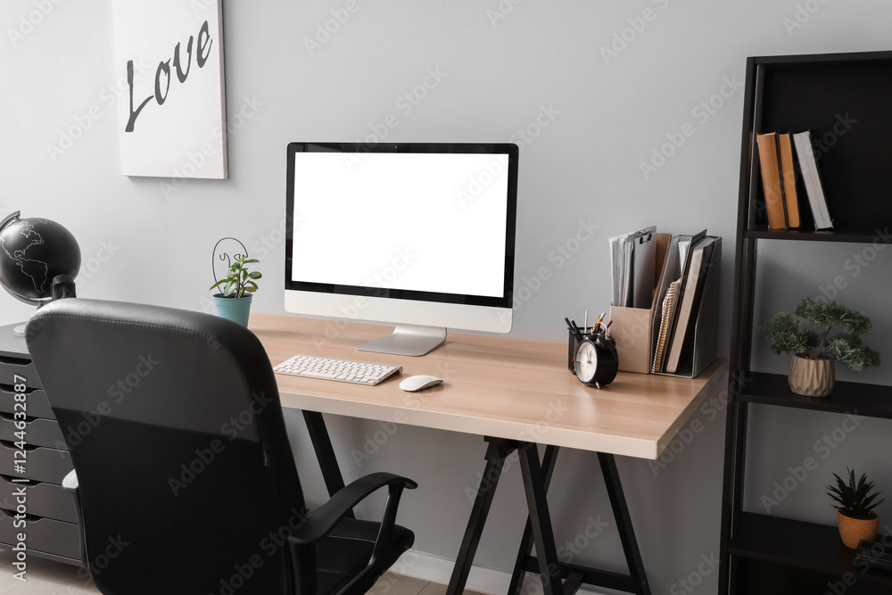 Aufkleber blank computer monitor with alarm clock on table in office