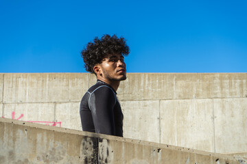 Portrait of a young Hispanic African man with a stern and combative expression in a construction...